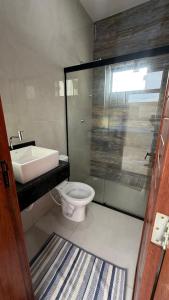 a bathroom with a toilet and a sink and a shower at Casa em tibau in Tibau