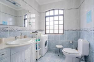 a white bathroom with a sink and a toilet at Casa das 3 Marias in Biscoito Bravo +25 photos