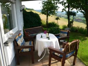 a table and chairs on the porch of a house at Ferienwohnung Ritter in Oberharmersbach