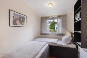 a small bedroom with a bed and a window at Ferienwohnung Becker in Schwalefeld