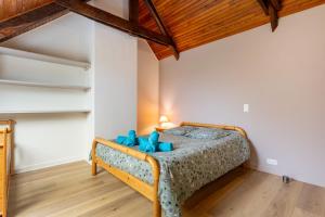 a bedroom with a bed with blue teddy bears on it at La longère familiale et authentique in Melgven