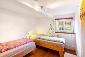 two beds in a room with a window at Ferienhaus Titz in Sundern