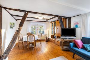a living room with a blue couch and a tv at Ferienhaus Titz in Sundern