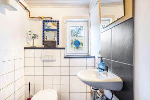 a bathroom with a sink and a toilet at Ferienhaus Titz in Sundern +36 photos