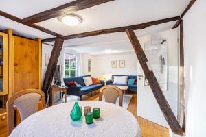a dining room and living room with a table and chairs at Ferienhaus Titz in Sundern