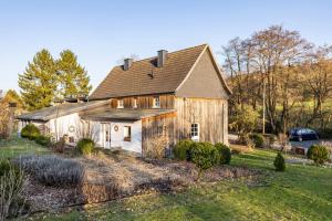 an old barn with a car parked in front of it at Ferienhaus Titz in Sundern