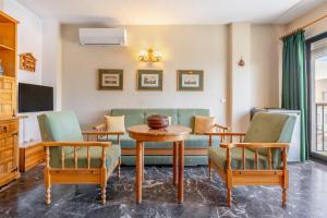 a living room with a table and chairs at El Tesorillo Andalúz in Almuñécar