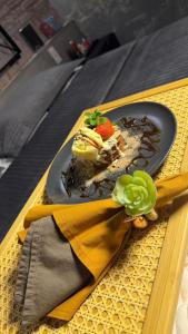 a plate of food with a dessert on a table at KANKUN MOTEL SOROCABA -Adult only in Sorocaba