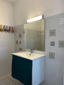 a bathroom with a sink and a mirror at Studio La Marguerite - Vue mer avec terrasse privée - calme tropical à Deshaies in Deshaies +40 photos