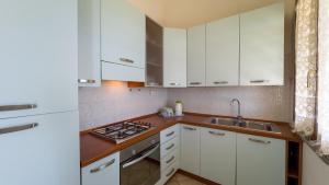 a kitchen with white cabinets and a sink at Blue Horizon Sinis in Funtana Meiga +28 photos
