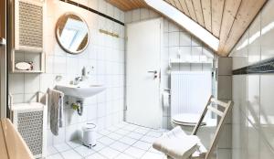 a white bathroom with a sink and a toilet at Casa Limone in Ammerbuch +62 photos
