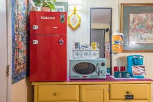 a microwave sitting on a counter next to a red refrigerator at Cozy Cabin in Helen