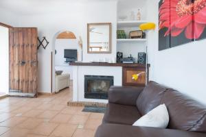 a living room with a couch and a fireplace at Can Divertit in Port de Soller