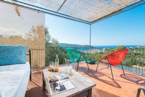 a living room with a couch and chairs on a patio at Can Divertit in Port de Soller