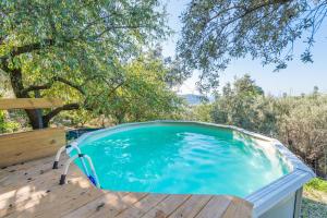 a swimming pool on a wooden deck with a wooden deck at Can Divertit in Port de Soller