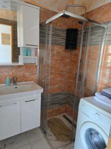 a bathroom with a washing machine and a sink at 6 M, 50 m do plaže in Barbat na Rabu +76 photos
