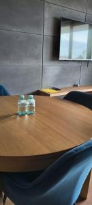 two jars sitting on top of a wooden table at Apartament 20 in Mysłowice