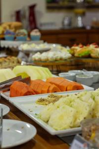 a table with several plates of food on it at Estância Avaré Hotel in Avaré