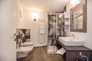 a bathroom with a sink and a toilet at Apartment Dui Residence Bun Ste in San Vigilio Di Marebbe +23 photos