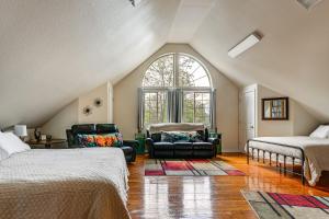 a attic bedroom with two beds and a window at Explore Caves & Coast! Family-Friendly Oregon Stay in Cave Junction