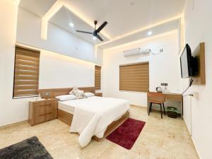 a bedroom with a bed and a flat screen tv at CRK Home Stays in Cochin