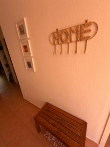 a bench sitting next to a wall with a towel rack at Lake view Appartment in Monflanquin
