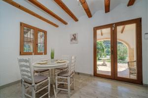 a dining room with a white table and chairs at Romántica Jávea -Solo Familias 1769 in El Tosalet