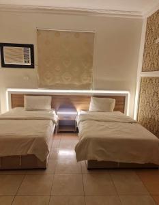 a room with two beds and a window at شاطئ الحوية in Taif