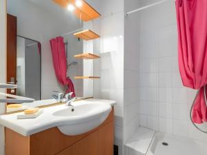 a bathroom with a sink and a red shower curtain at Maison de la plage in Valras-Plage +31 photos