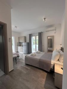 a bedroom with a large bed and a kitchen at Vila Melina in Himare +133 photos