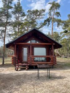 a log cabin with a bench in front of it at Spokiy in Glebovka