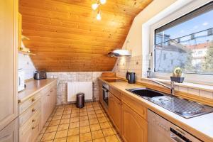 a kitchen with a sink and a window at Ferienwohnung Sonnenblick in Albstadt +18 photos