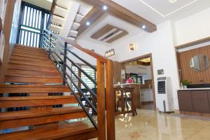 a staircase in a home with wood and white walls at CRK Home Stays in Cochin