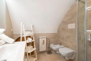a bathroom with a toilet and a sink at Casa Tuccia in Ostuni +19 photos