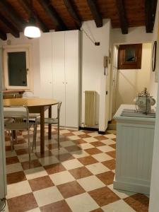 a dining room with a table and a checkered floor at Ca' Molinetto in Treviso