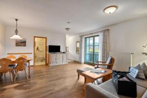 a living room with a couch and a table at Fewo Brünnstein - Nr 40 Pool, Sauna in Oberaudorf