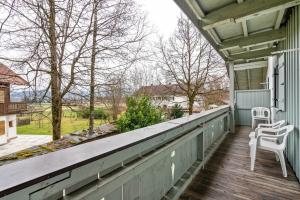 a porch with two white chairs on it at Fewo Brünnstein - Nr 40 Pool, Sauna in Oberaudorf