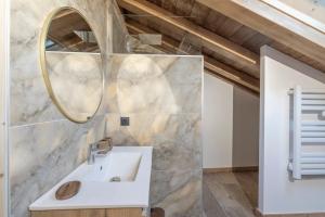 a bathroom with a sink and a mirror at Albert le Cerf in Morillon +17 photos