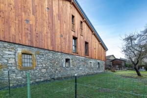 a large stone building with a fence in front of it at Albert le Cerf in Morillon