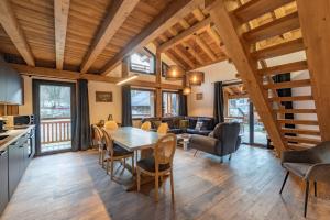 a kitchen and living room with a table and chairs at Albert le Cerf in Morillon