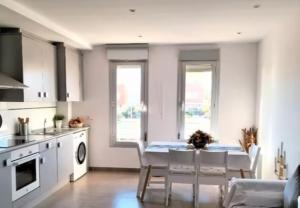 a kitchen with a table and chairs in a room at Duplex Mediterranea in Benicarló