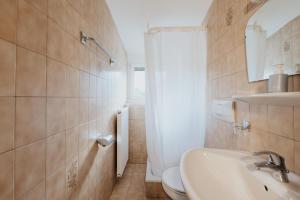 a bathroom with a sink and a toilet at Unterhauserhof App B in Valdaora +7 photos