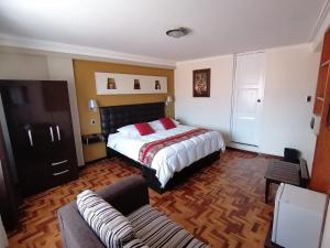a hotel room with a bed and a couch at Hotel Juan in Arequipa