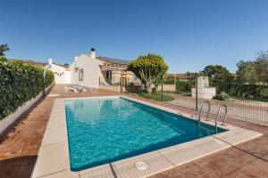 a swimming pool in the backyard of a house at Finca Liarte in Murcia