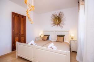 a bedroom with a white bed in a room at Oasis del Sol in Llombarts +28 photos