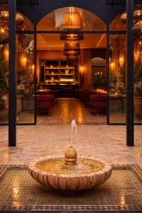 a fountain in the middle of a building at Riad Jawad & Spa in Marrakesh