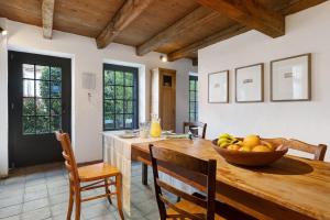a kitchen with a wooden table with a bowl of fruit at Loft Im Künstlerhaus in Riegel am Kaiserstuhl