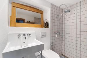 a bathroom with a sink and a toilet and a mirror at Loft Im Künstlerhaus in Riegel am Kaiserstuhl +17 photos
