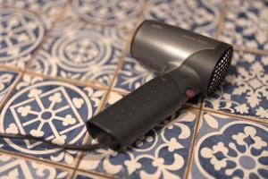 a hair dryer sitting on top of a table at Loft Im Künstlerhaus in Riegel am Kaiserstuhl