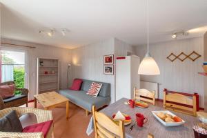 a living room with a table and a couch at Möve Aba Bungalow 67 in Rerik
